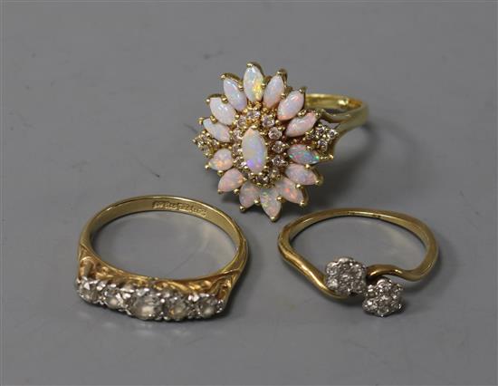 An 18ct yellow gold and diamond half-hoop ring, an 18ct gold and opal cluster ring and a diamond crossover ring.